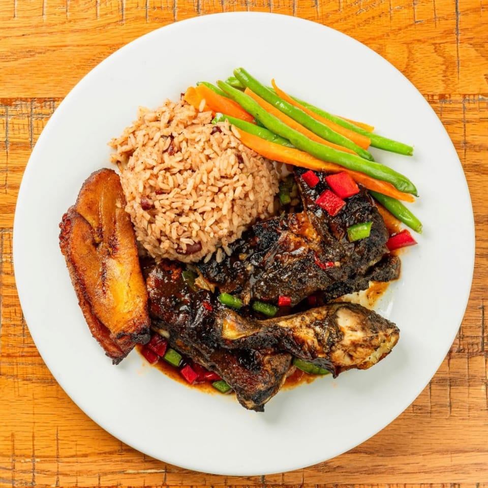 Dunns River Jamaican jerk chicken with rice, plantains, green beans, and carrots.